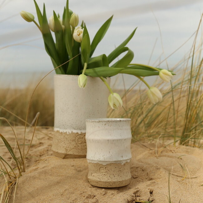A ceramic handmade white vase with elegant artistic shapes