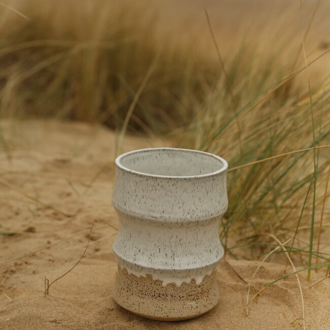 A ceramic handmade white vase with elegant artistic shapes