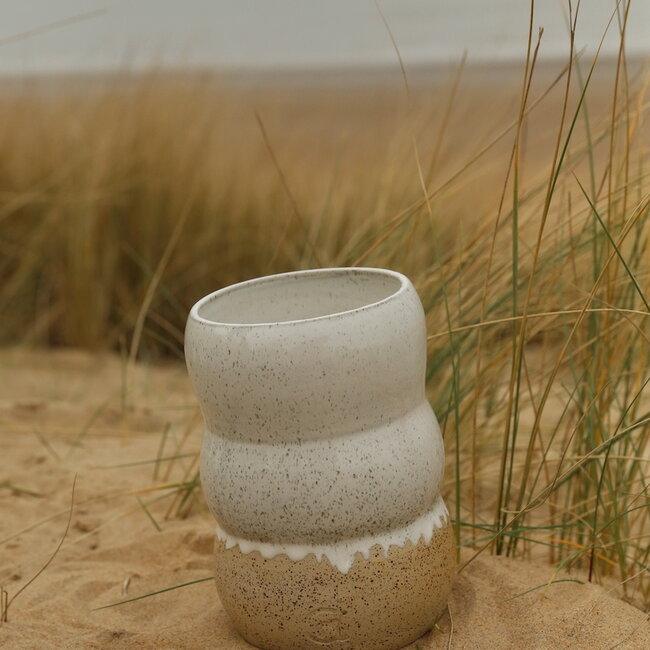 A ceramic handmade white vase with elegant artistic shapes round