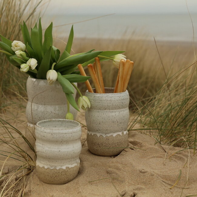 A ceramic handmade white vase with elegant artistic shapes round