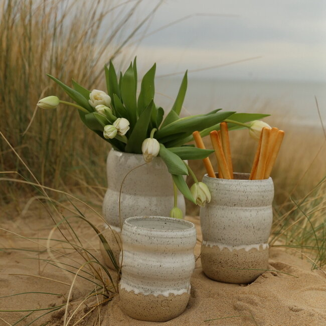 A ceramic handmade white vase with elegant artistic shapes round