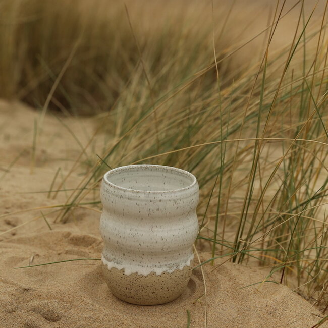 A ceramic handmade white vase with elegant artistic shapes round