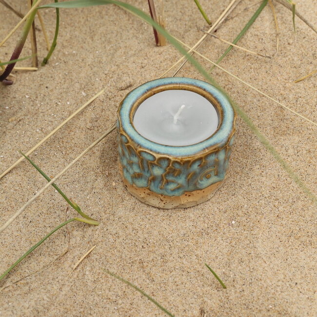 Handmade ceramic tealight holder decorated with the carving technique