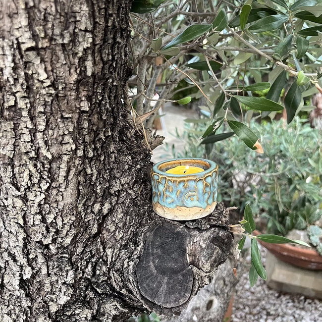 Handmade ceramic tealight holder decorated with the carving technique