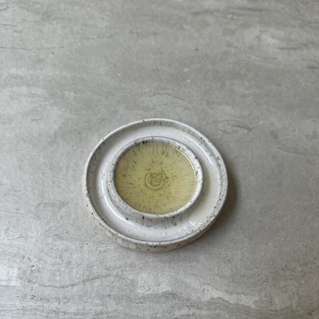Handmade small ceramic oil dish with the turntable in a beautiful white glaze