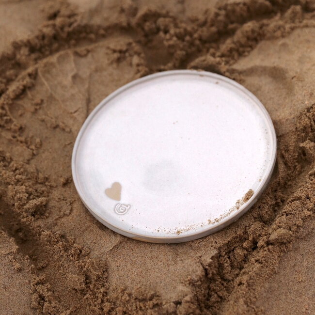 Handmade white ceramic plate from the tableware and collection “White Love" with a little heart