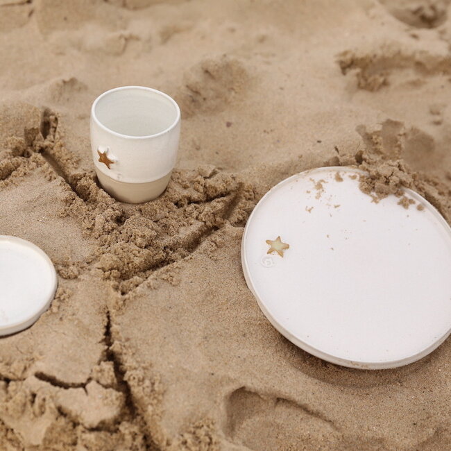 White handmade ceramic plate from the tableware and collection “White Star" with a musterd-colored star
