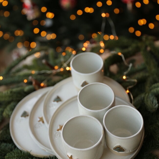 White handmade ceramic cup from the “White Tree” service with a mint-colored star