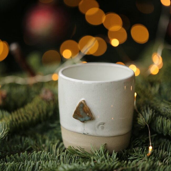 White handmade ceramic cup from the “White Tree” service with a mint-colored star