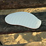A unique handmade porcelain plate with a wave structure to present snacks, tapas pastries
