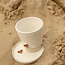White handmade ceramic tea cup from the “White Heart” service with a sungreen-colored star