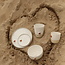 White handmade ceramic tea cup from the “White Heart” service with a sungreen-colored star