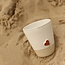 White handmade ceramic tea cup from the “White Heart” service with a sungreen-colored star