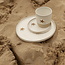 White handmade ceramic cup from the “White Star” service with a mustard-colored sea star