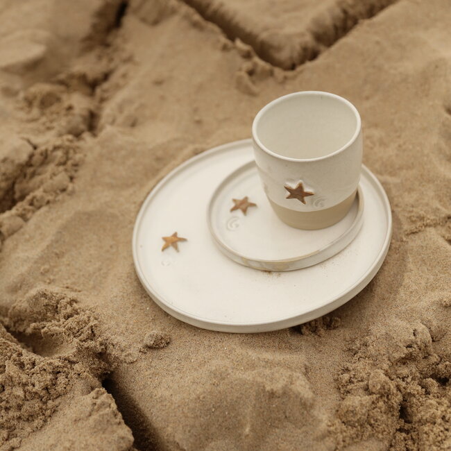 White handmade ceramic plate from the tableware and collection “White Star" with a musterd-colored star