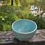 With the turntable handmade bowl of Puerite clay with a beautiful Floating green high-firing glaze.