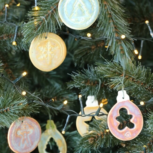 Handmade porcelain Christmas ball decorated with a star, doll, or Christmas tree