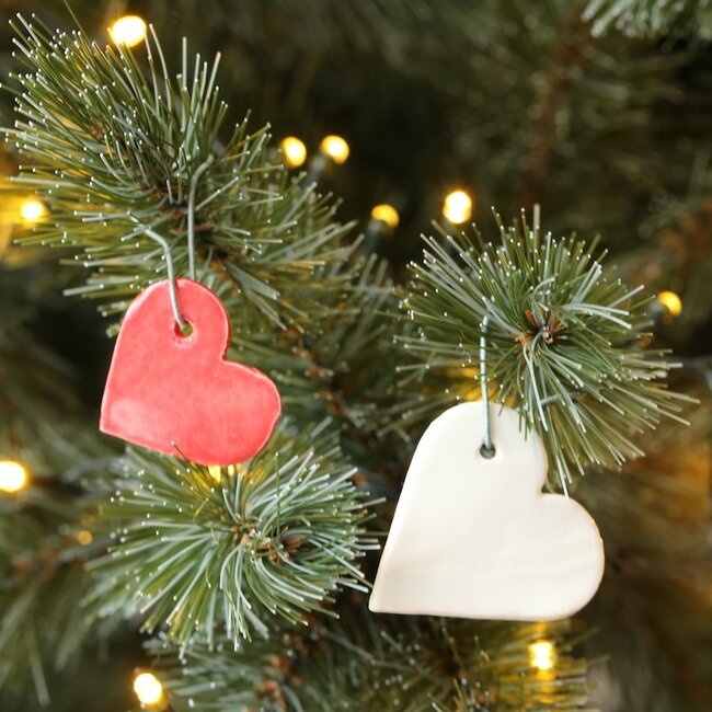 Handmade white or red porcelain heart, a gesture of love