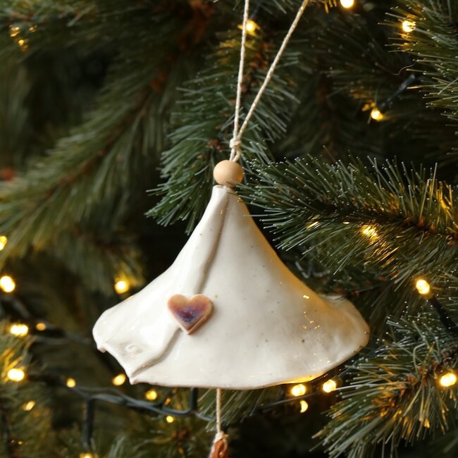 Handmade porcelain Christmas bell decorated with a Christmas figurine