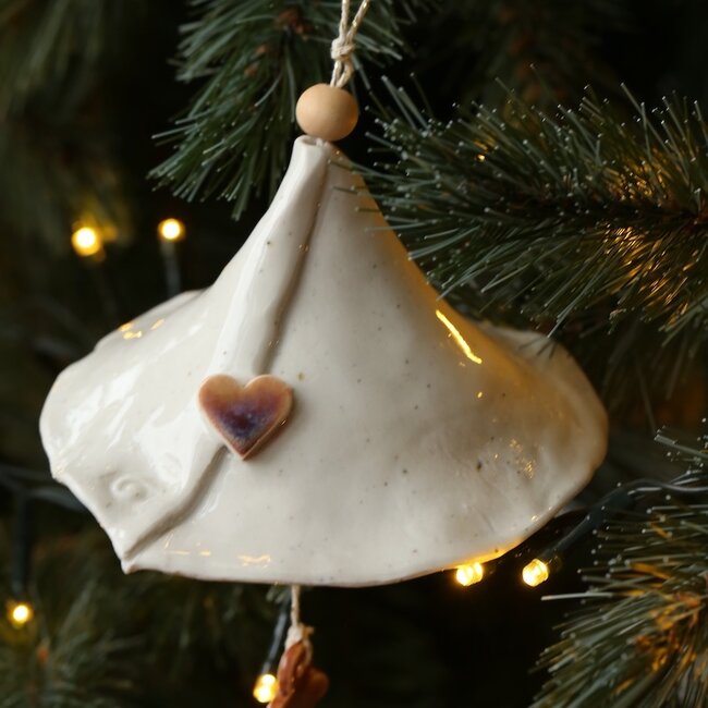 Handmade porcelain Christmas bell decorated with a Christmas figurine