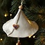 Handmade porcelain Christmas bell decorated with a Christmas figurine