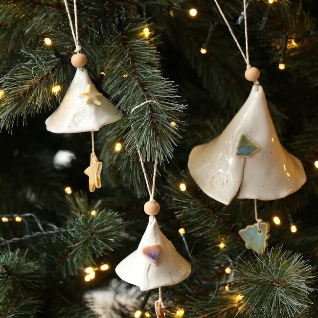 Handmade porcelain Christmas bell decorated with a Christmas figurine