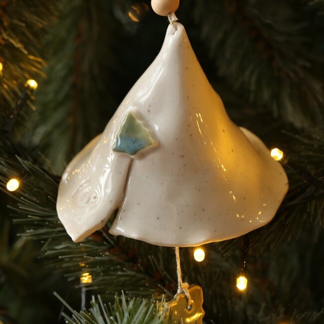 Handmade porcelain Christmas bell decorated with a Christmas tree