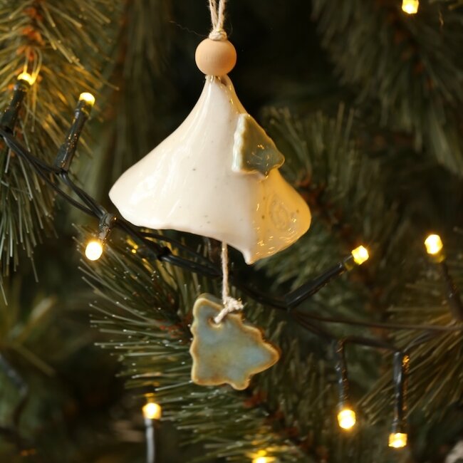 Handmade porcelain Christmas bell decorated with a Christmas tree