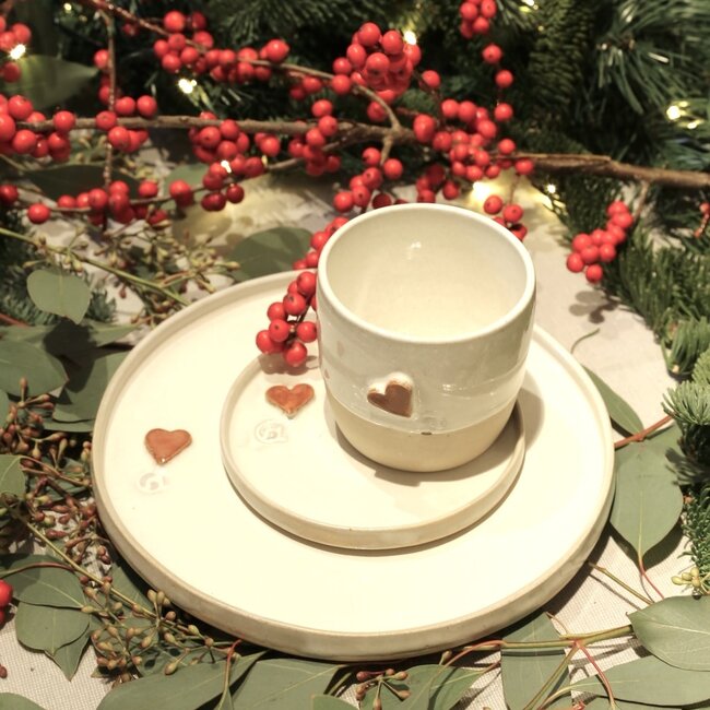 White handmade ceramic cup from the “White Heart” service with a sungreen-colored heart