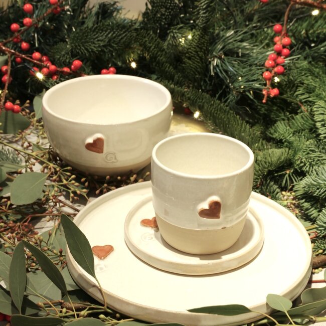 White handmade ceramic cup from the “White Heart” service with a sungreen-colored heart
