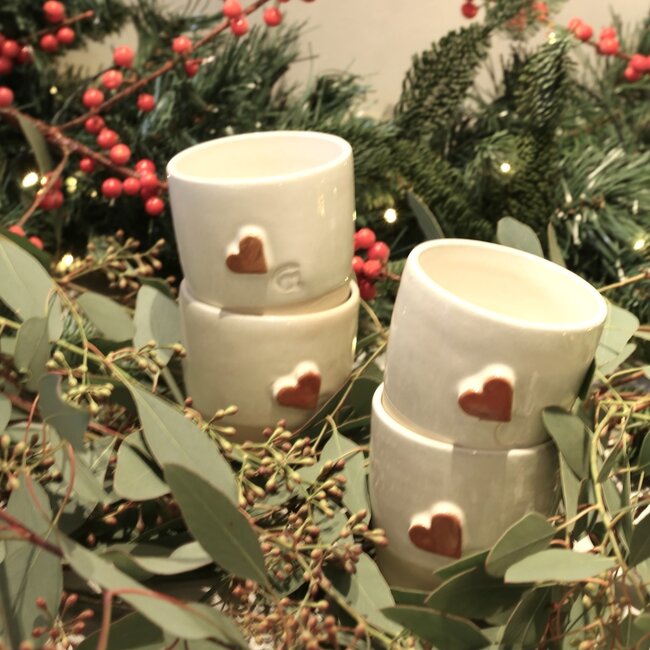 White handmade ceramic cup from the “White Heart” service with a sungreen-colored heart
