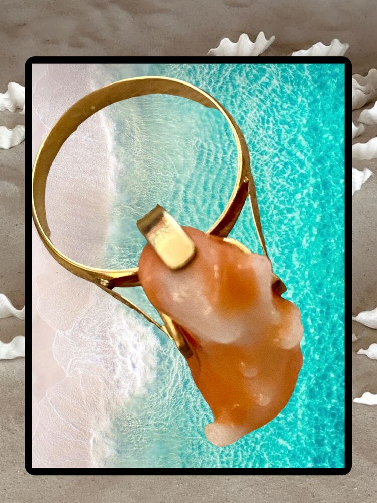 Unpolished Angelskin pink coral in a 14 crt gold setting