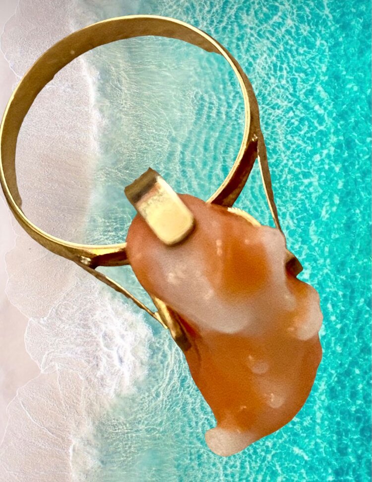 Unpolished Angelskin pink coral in a 14 crt gold setting