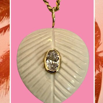 White stone leaf charm with pink Topaz in a 14 crt gold setting
