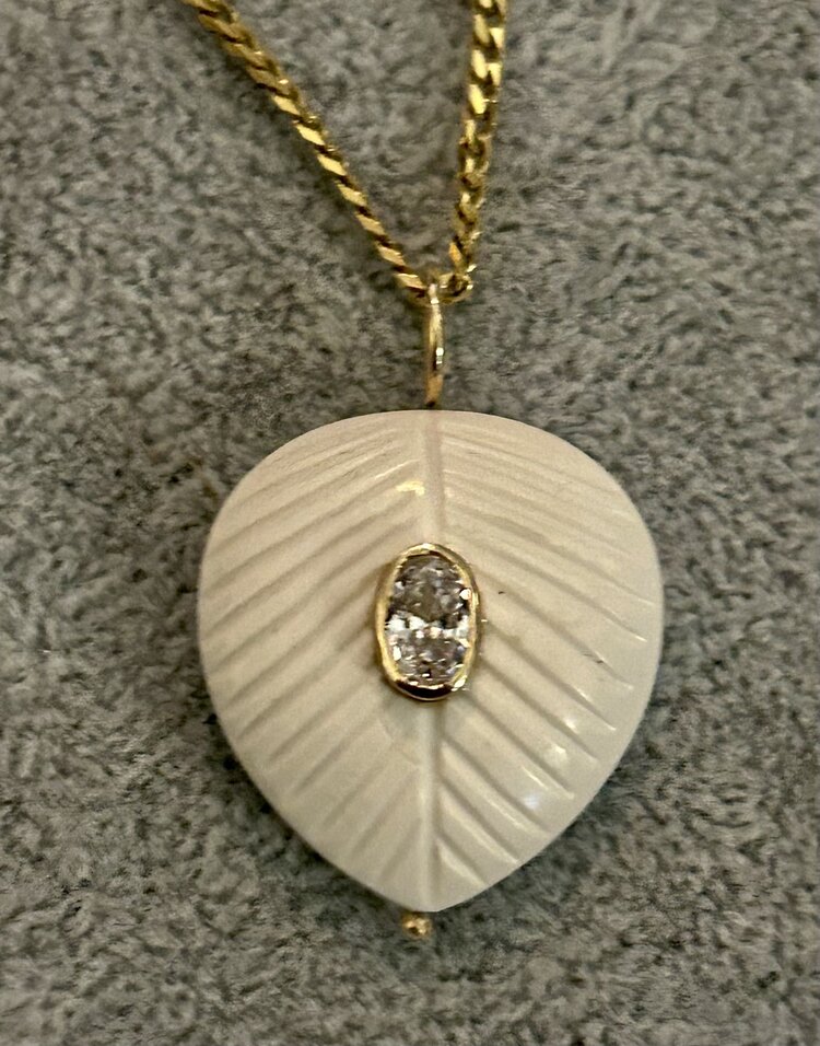 White stone leaf charm with pink Topaz in a 14 crt gold setting