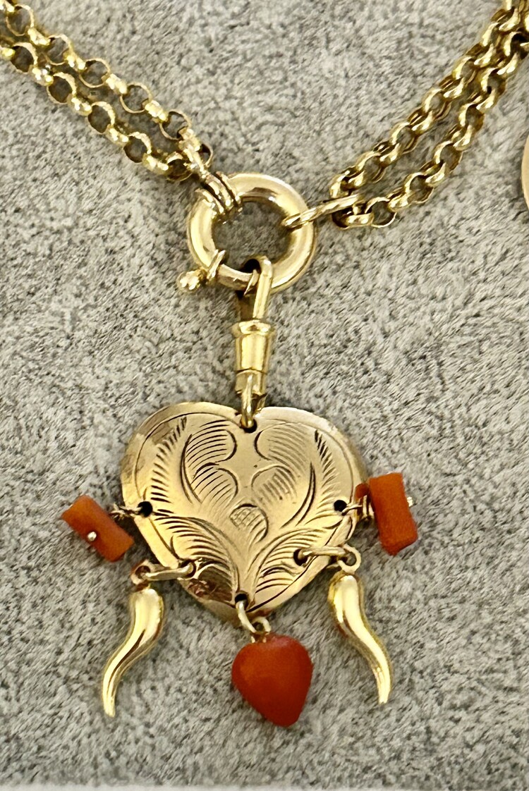 Carved handcasted heart with coral  and14 crt gold details and lock
