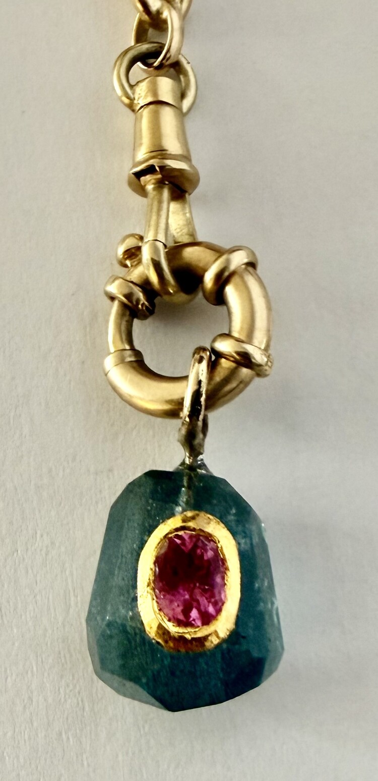 rough unpolished Emerald with Ruby inlay 18 crt