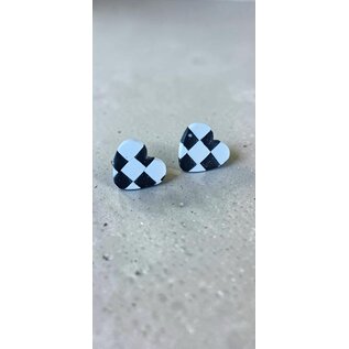 Handcrafted clay earrings with a black and white checkerboard pattern and butterfly backs.