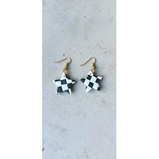 Handcrafted clay drop earrings with a black and white checkerboard pattern.
