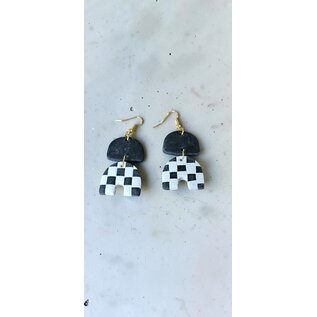 Handcrafted clay drop earrings with a black and white checkerboard pattern.
