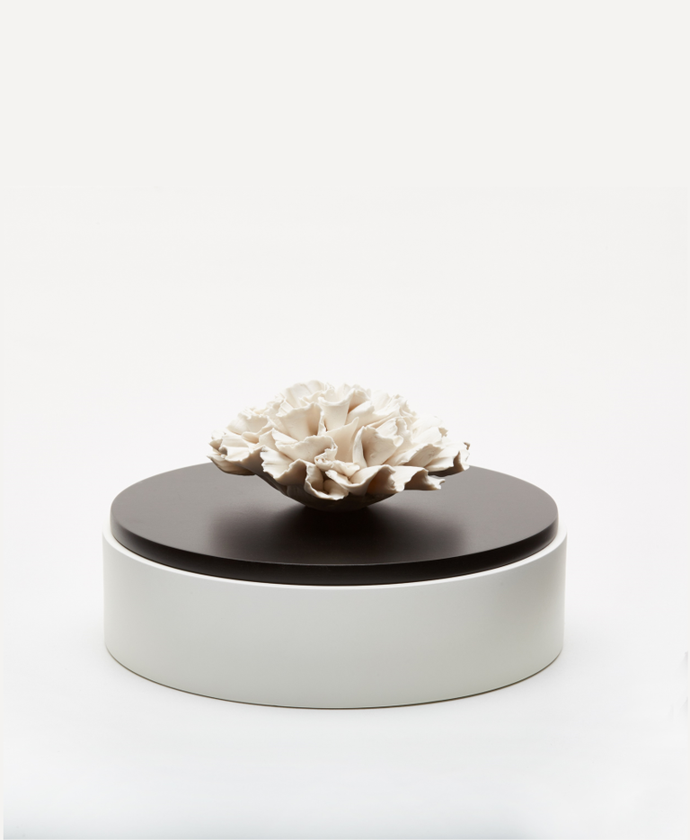 Anoq Round white wooden box with white porcelain flower on black lid.