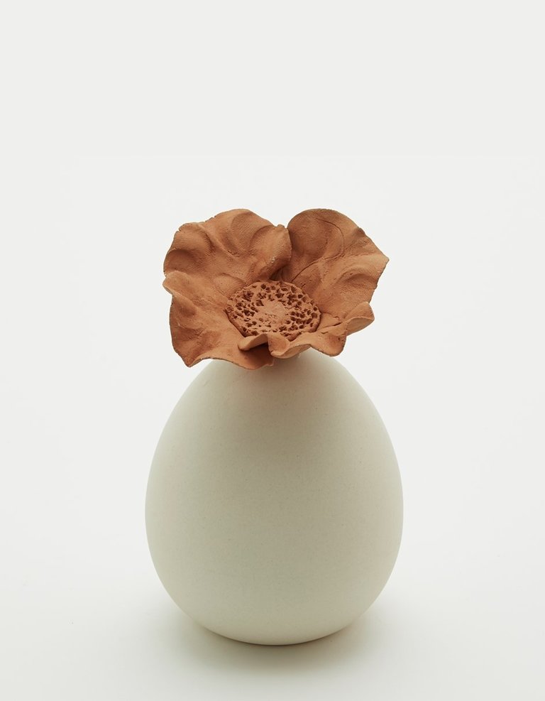 Cream colored ceramic perfume diffuser reservoir with flower