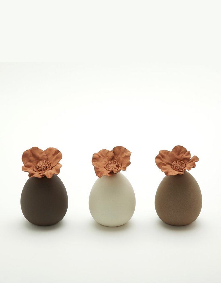 Cream colored ceramic perfume diffuser reservoir with flower