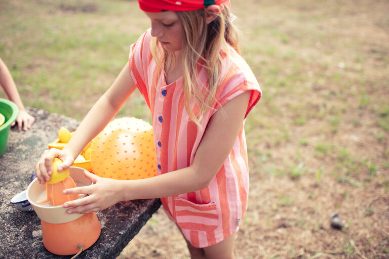 Piupiuchick short sleeveless jumpsuit | orange & pink stripes