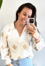 Witte blouse met gouden borduursel