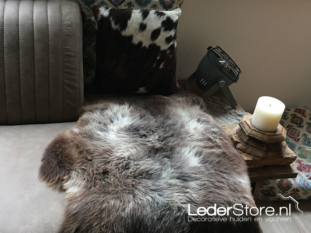 Agnes cowhide pillow and sheepskin on sofa