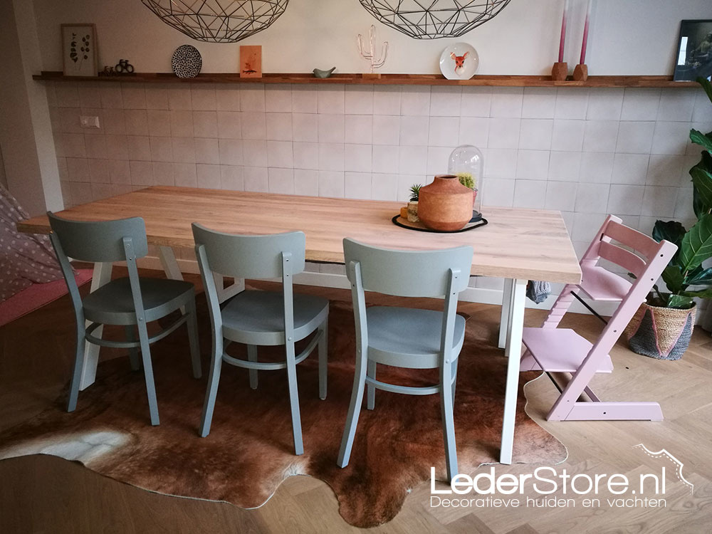 Brown cowhide in kitchen under dining table Silvia