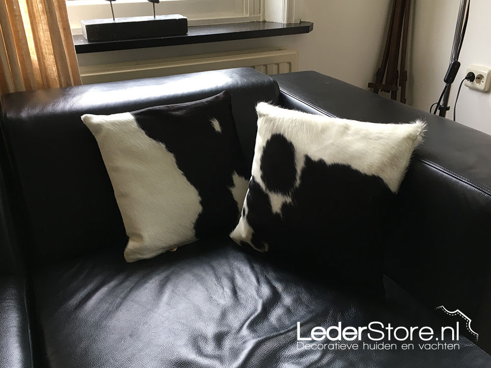 Cowhide cushions black and white on sofa in living room