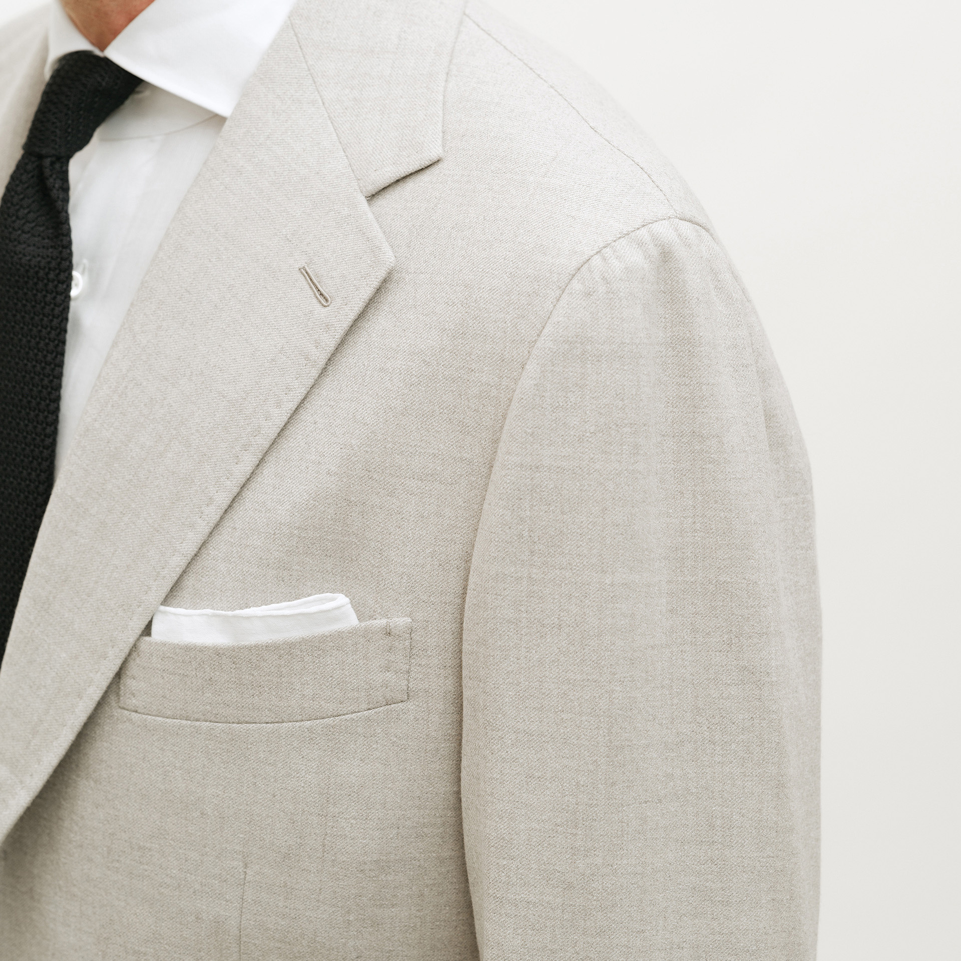 Shoulder detail and hand-stitched Milanese buttonhole