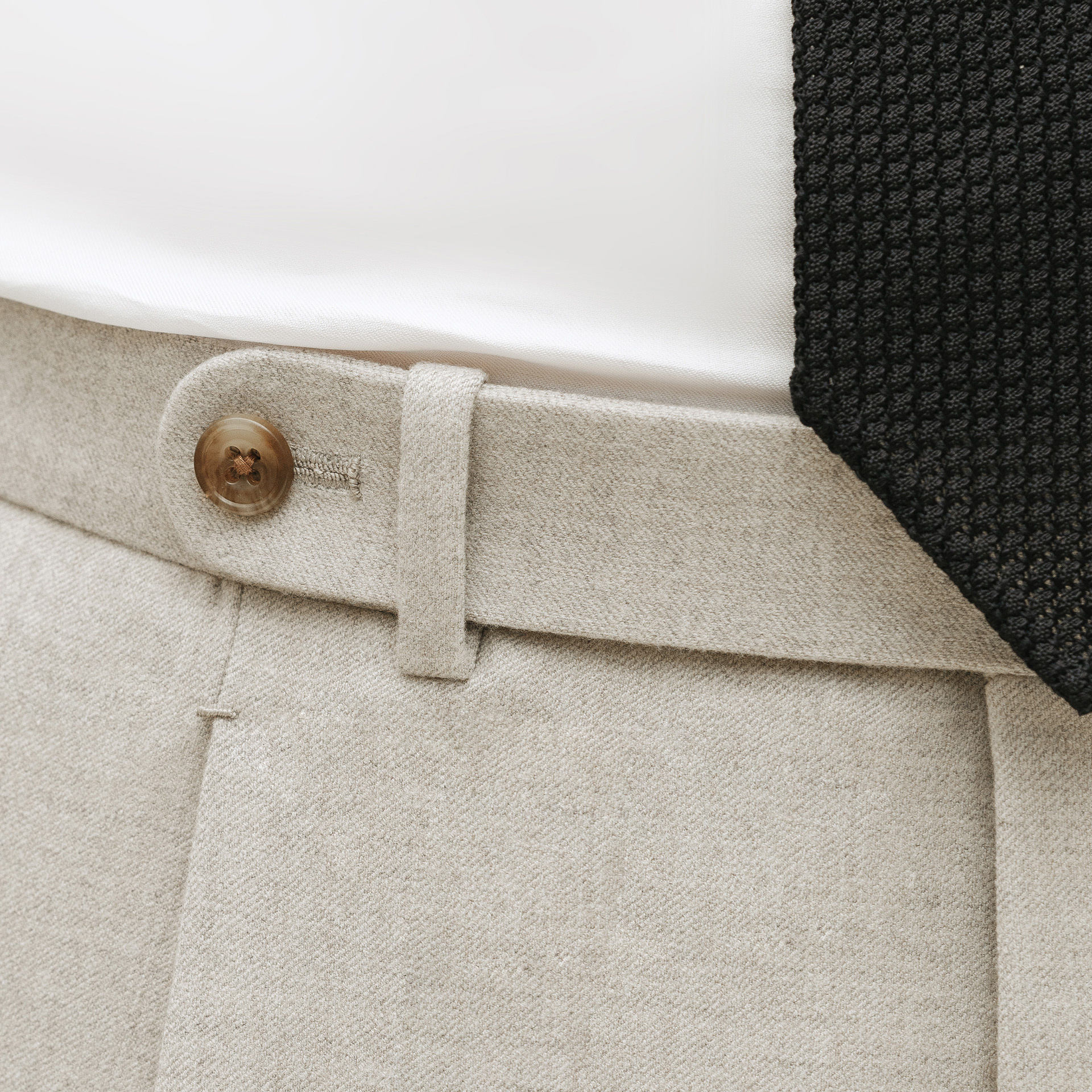 Waistband and pleats detail of tailored trousers